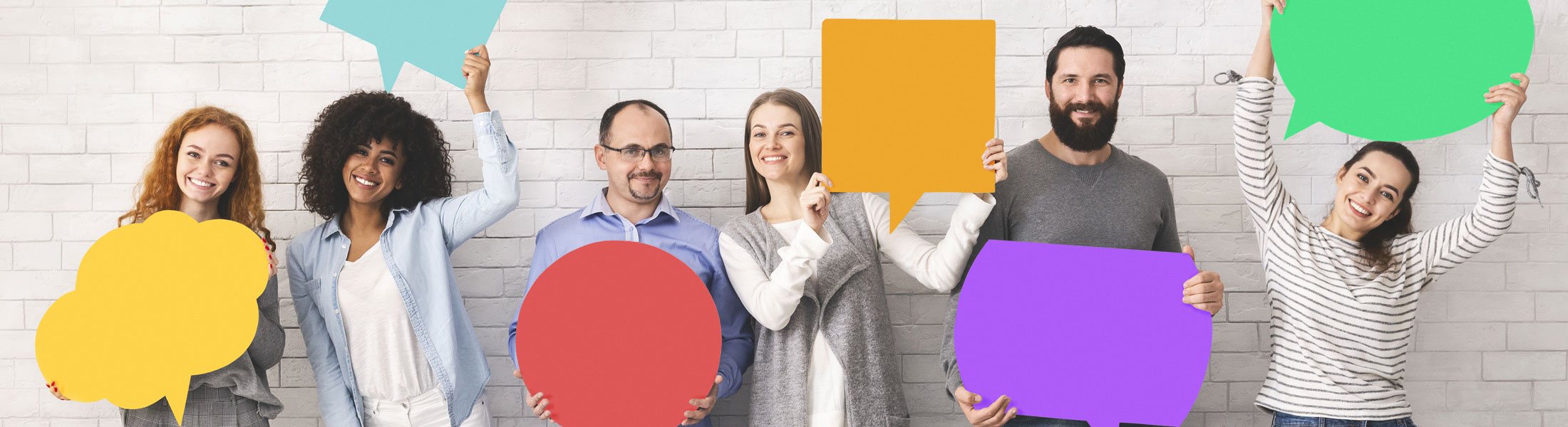 people holding paper speech bubbles